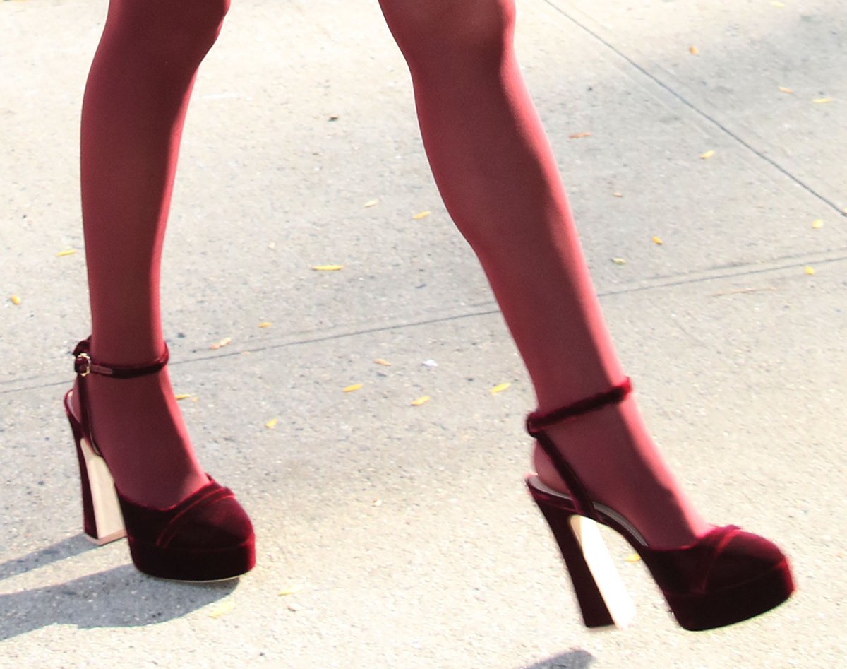 Anna Kendrick completes her head-to-toe burgundy look with red tights and burgundy suede Malone Souliers Mora platform pumps