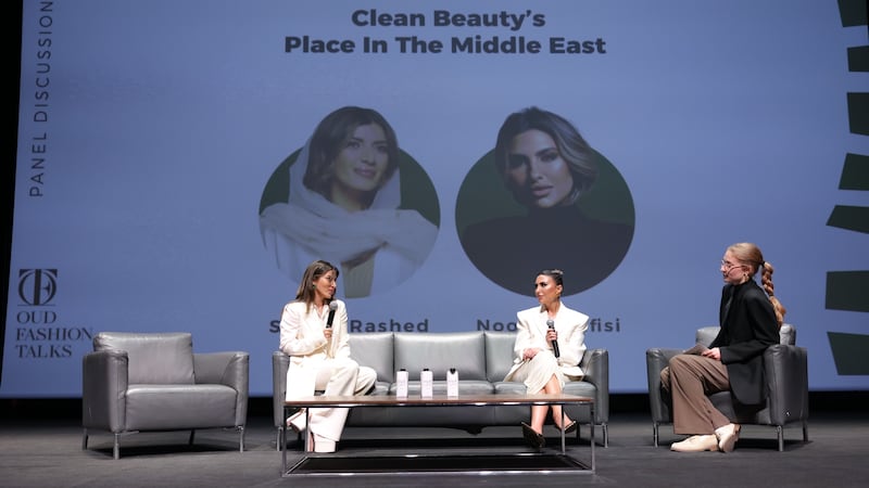 Three individuals onstage for a panel discussion. Behind them, a screen reads: "Clean Beauty's Place in The Middle East".