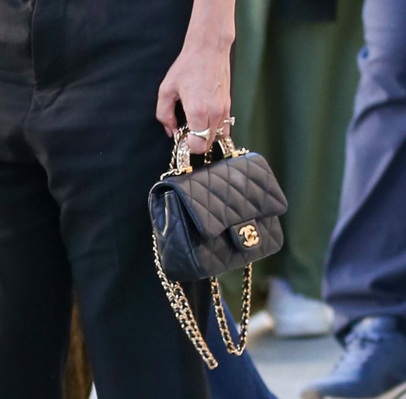 Jennifer Lopez carries her daytime essentials in the Chanel Perfect Edge bag featuring a clear top handle