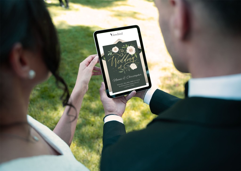 Couple looking at Lovebird wedding platform on an ipad