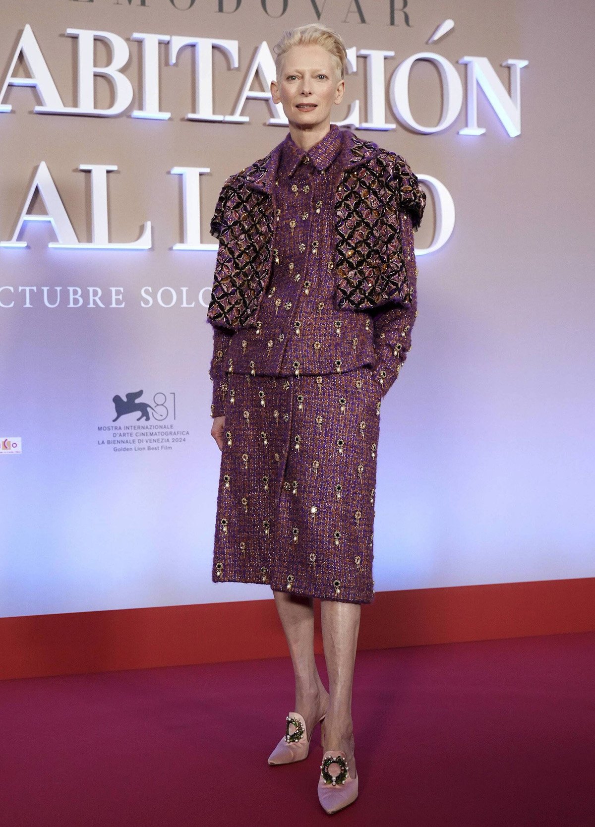 Tilda Swinton embraces maximalism in a burgundy tweed Chanel skirt suit with a cropped bolero jacket