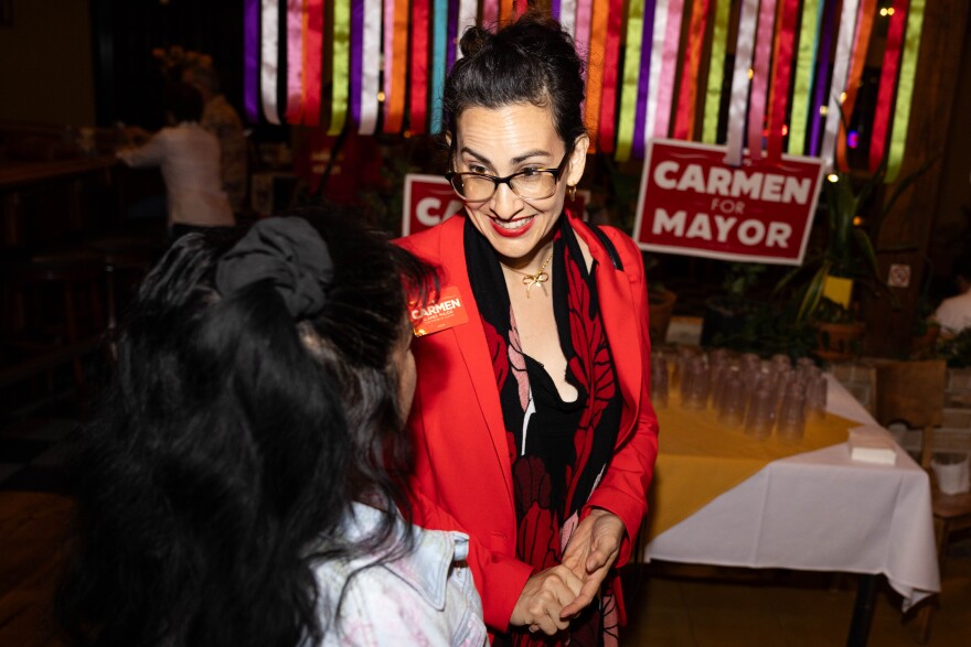 Carmen Llanes speaks to supporter on Election day at a watch party at El Mesón Tequileria.