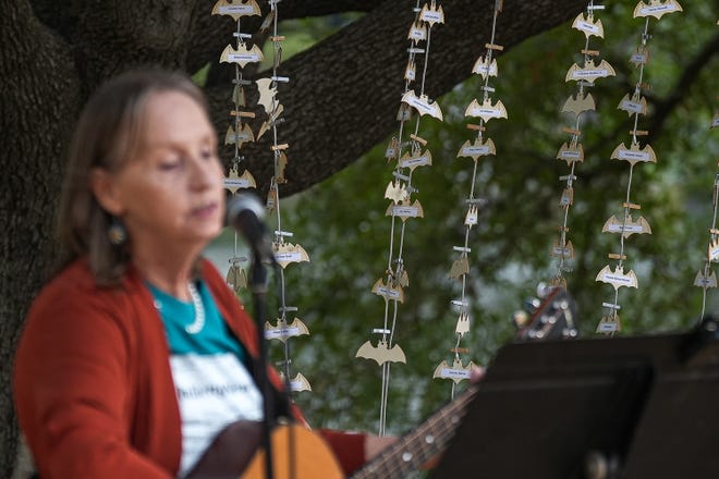 Small wood bats are labeled with the names of deceased homeless people and are displayed at a memorial service at Auditorium Shores on Sunday, Nov. 17, 2024 in Austin. Advocates and members of the homeless community gathered to honor the more than 200 homeless people that died between September of 2023 and November of 2024.