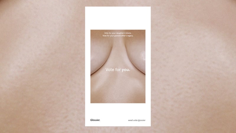 A close crop between a pair of bare breasts is decorated with the text "Vote for your daughter's future, vote for your grandmother's legacy, vote for you," and a link to voter registration.