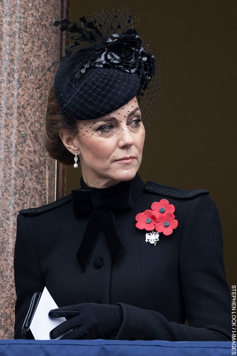 The Princess of Wales wears a black military-inspired coat by Catherine Walker with epaulettes on the shoulders and a bow at the neckline. 