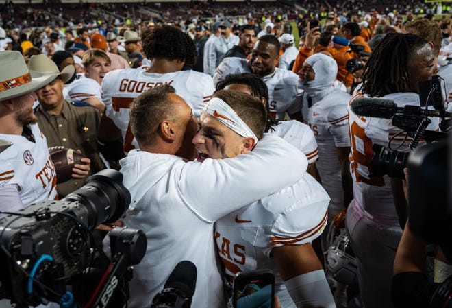 Texas Longhorns head coach Steve Sarkisian embraces defensive back Michael Taaffe after the Longhorns' 17-7 victory in the Lone Star Showdown against the Texas A&M Aggies at Kyle Field in College Station on Saturday.