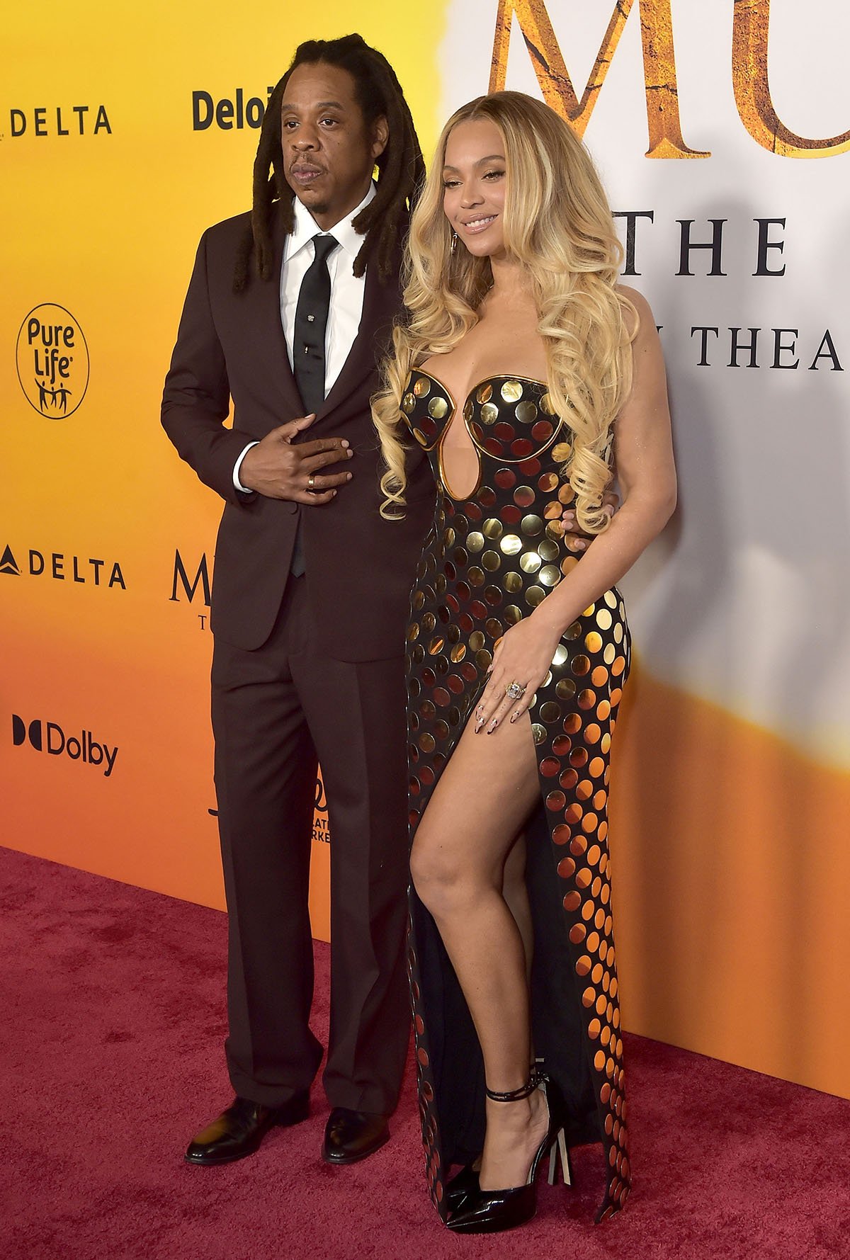 Jay-Z shows his support for his wife, Beyoncé, and daughter, Blue Ivy, in a brown suit with a white shirt, black necktie, and black loafers