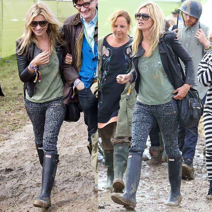 Kate Moss brings rocker-chic vibes to the muddy Glastonbury Festival in snake-print jeans, a leather jacket, and classic Hunter boots on June 25, 2011, at Worthy Farm in Somerset, England