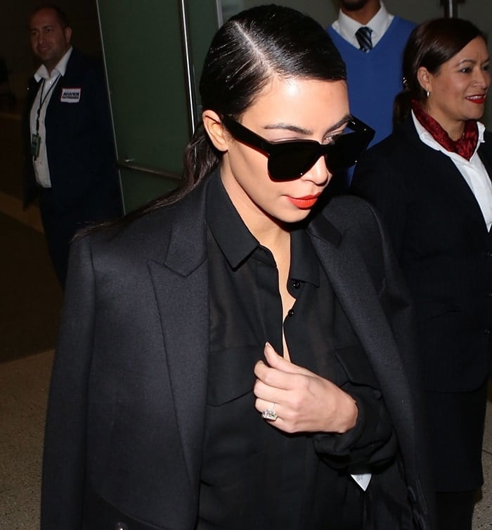 Shielding her eyes from the paparazzi's flashes, Kim Kardashian opted for oversized sunglasses at LAX