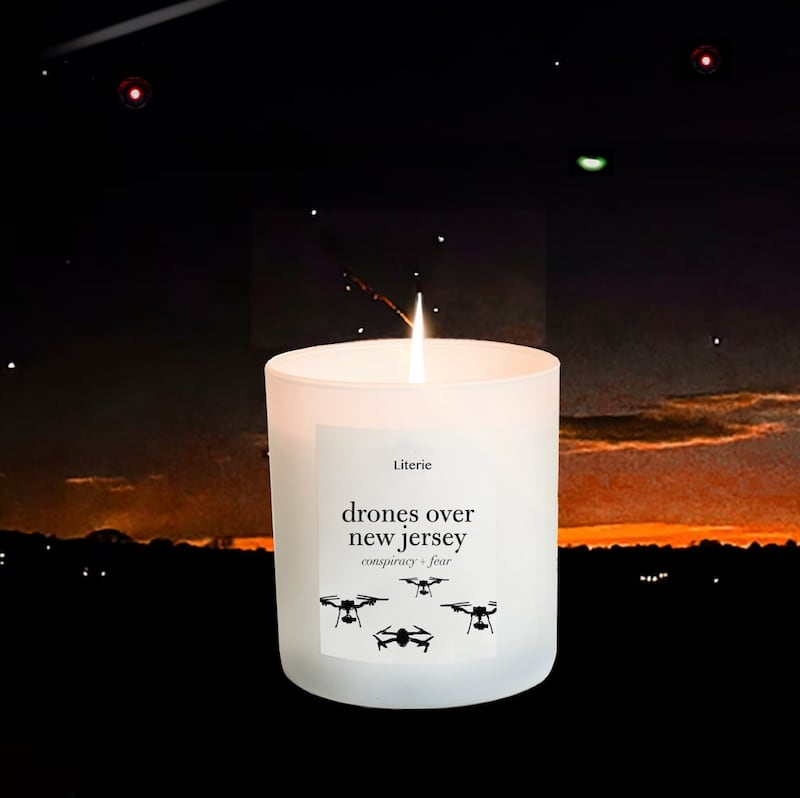 A white candle, placed on a background of a New Jersey neighborhood at night, reads "Drones Over New Jersey."